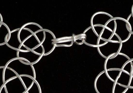 Clasp for silver graduated knotted chain mail necklace.