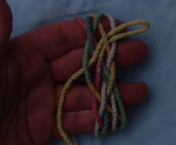 Tying a seven-lead eleven-bight knot in hand.