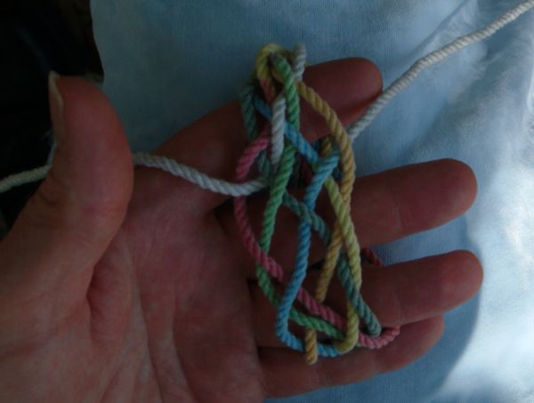Tying a seven-lead twelve-bight knot in hand.