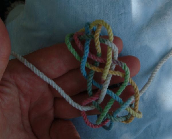 Tying a seven-lead twelve-bight knot in hand.