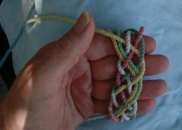Tying a seven-lead nine-bight knot in hand.